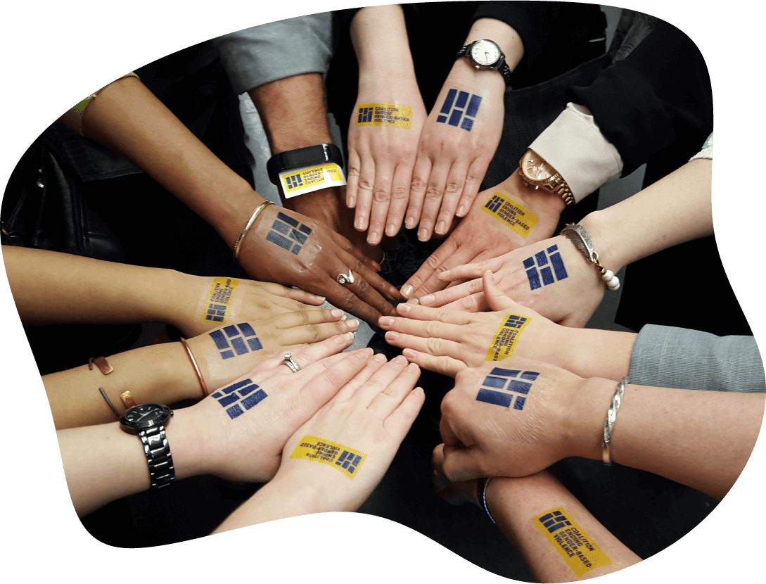 Photograph of many hands in a circle. Every arm or hand has a CEGV temporary tattoo  on it. Photo cropped in an organic blob shape